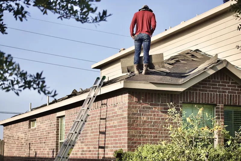 Professional roofer working on a residential roof in Trail Springs